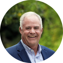 Chris Bagley wearing a suit and smiling