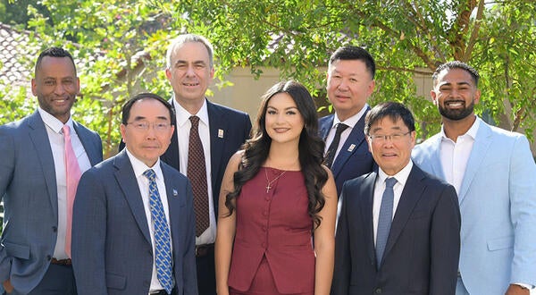 Damon Richardson, James Merino, Chancellor Jack Hu, Undergraduate student Shayla Michel, Michael Xu, Dean Yunzeng Wang, and MBA student Rhowen Raju