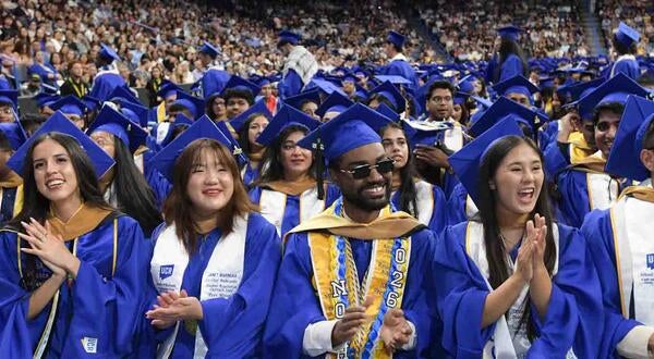 UCR Business graduating students in blue regalia at Toyota Arena