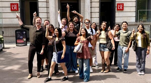 Kyle Ingram and his students posing in front of the London School of Economics campus