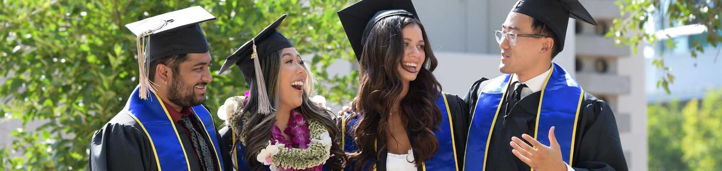 4 graduate students at Commencement 2022