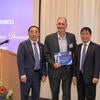 Chancellor Jack Hu, Former Executive Fellow Mickey McGuire, and Dean Yunzeng Wang standing together.