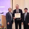 Chancellor Jack Hu, Executive Fellow James Merino, and Dean Yunzeng Wang standing together.