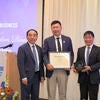 Chancellor Jack Hu, Executive Fellow Michael Xu, and Dean Yunzeng Wang standing together.