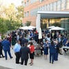 Attendees of the Executive Fellows Installation Dinner mingling behind the School of Business Building