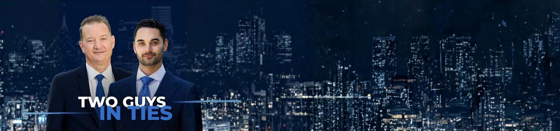 Dean's Speaker Series: Two guys in Ties in front of a night city skyline
