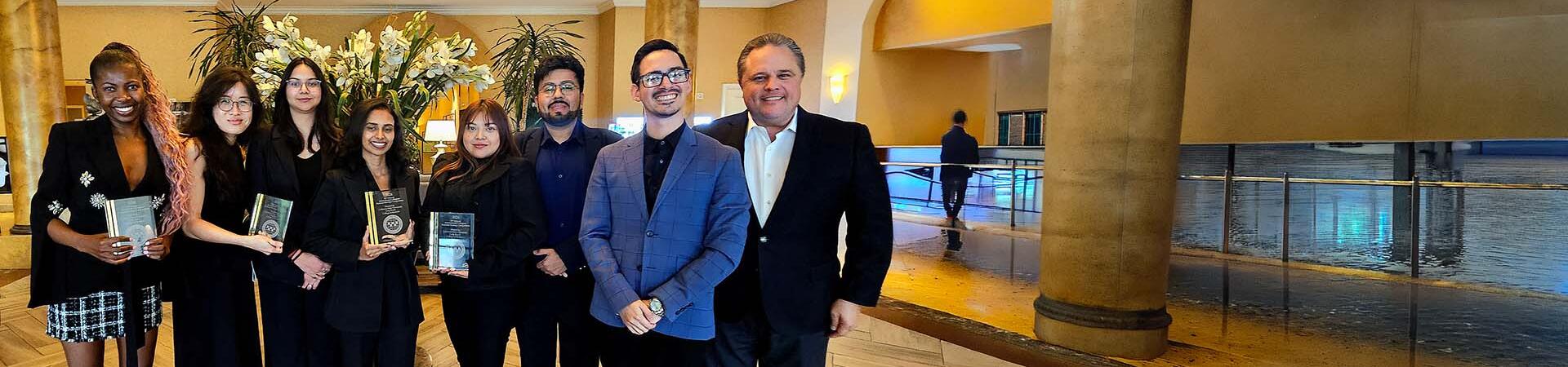 Professor Sean Jasso along with MBA students holding their awards for the International Collegiate Business Strategy Competition