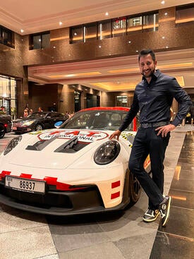 UCR School of Business Alumnus Arun Surendra with a Porsche