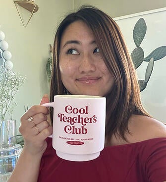 Lecturer Karisa You with a mug "Cool Teachers Club"