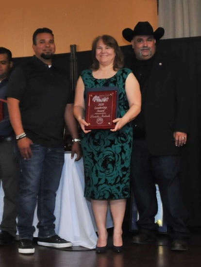 Daniela Andrade, PMBA ’22, former Banning city mayor, center, received the Leadership Award at a ceremony with Banning Chamber of Commerce presenters David Lopez, chamber secretary, left, and Robert Ybarra, chamber president, right.