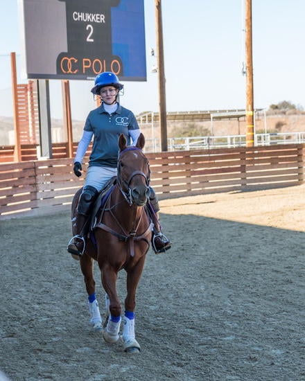 Marlo Raveendran, assistant professor of management, playing polo