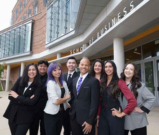 UCR School of Business graduate students posing in front of the building