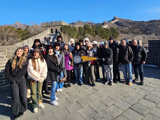 UCR School of Business students standing atop the Great Wall of China