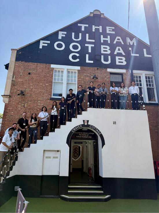 Kyle Ingram and Leadership Experience study abroad students in front of the Fulham Football Club building