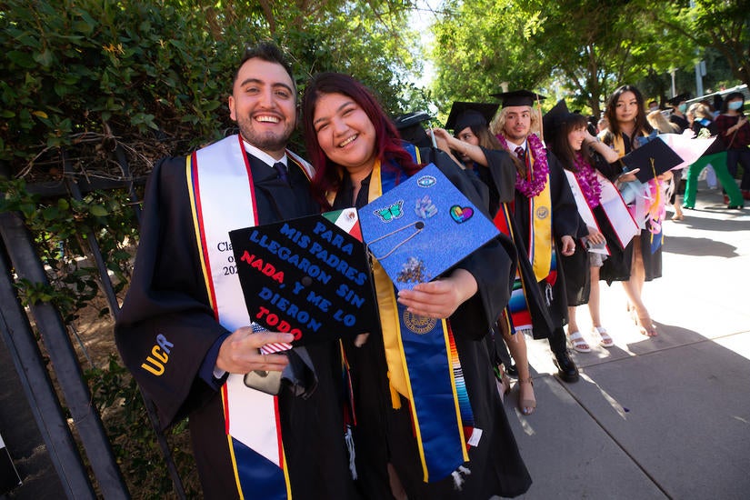 Raymond Jimenez, 28, and his classmate, celebrate on Saturday, June 12, 2021. (UCR/Stan Lim)